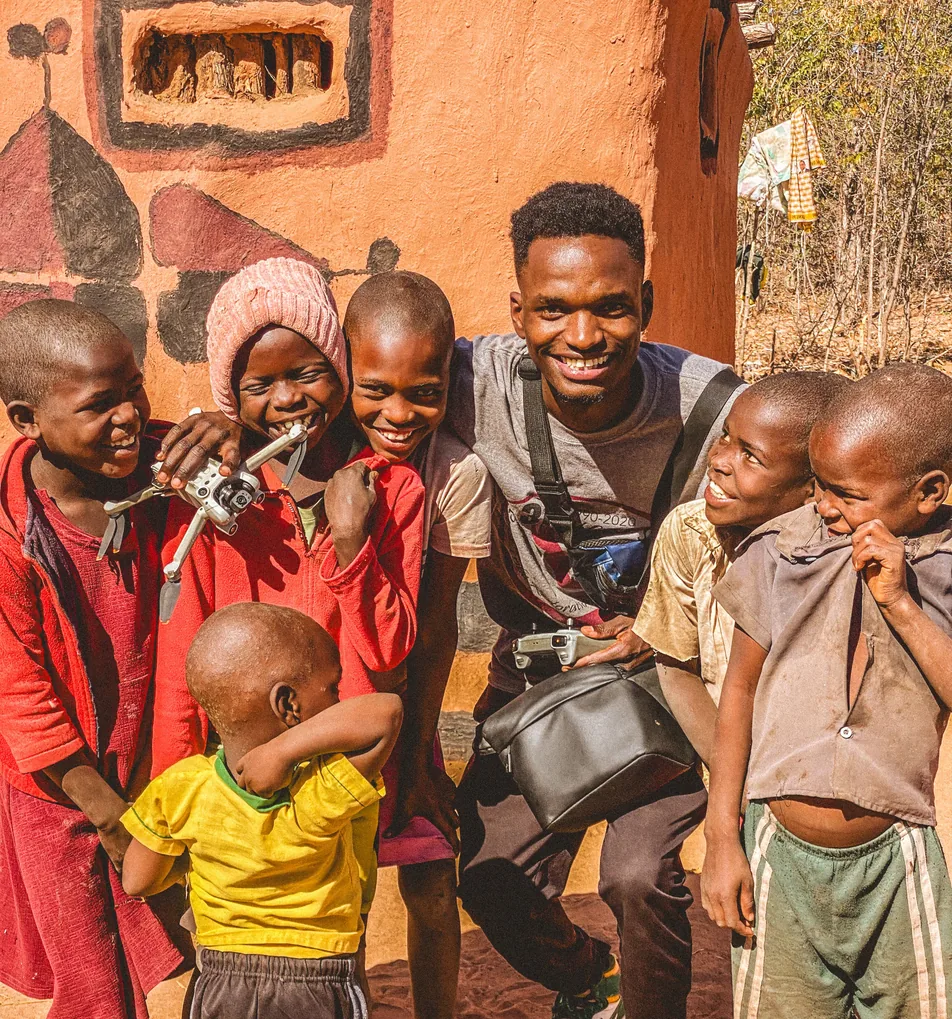 Children gathered around a Tigzozo Media camera operator