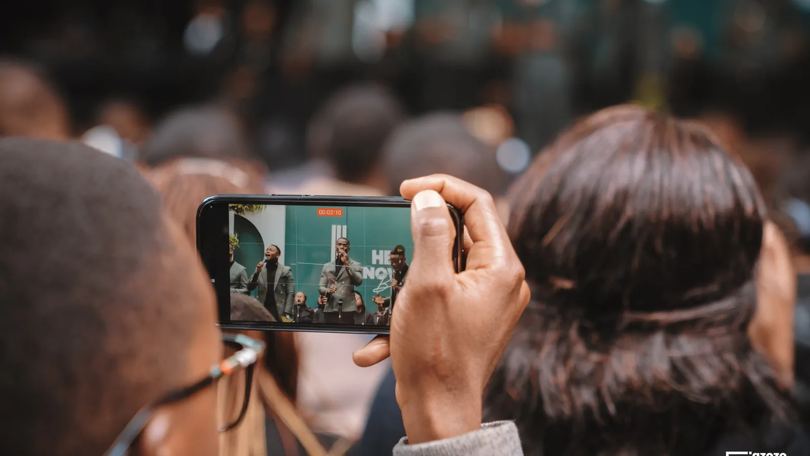Phone filming a live performance for social media